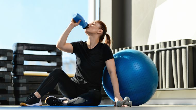 A person drinking pre-workout.