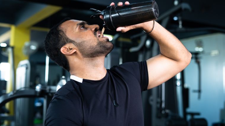 An athlete drinking pre-workout. 