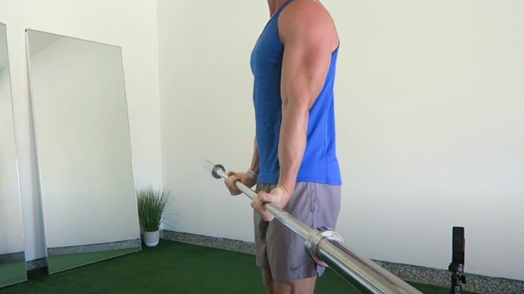 Flexing the wrist to curl the barbell for the wrist curls.