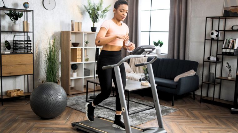 A person using a treadmill at home. 