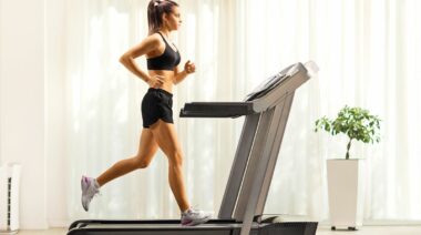A person running on a treadmill at home.