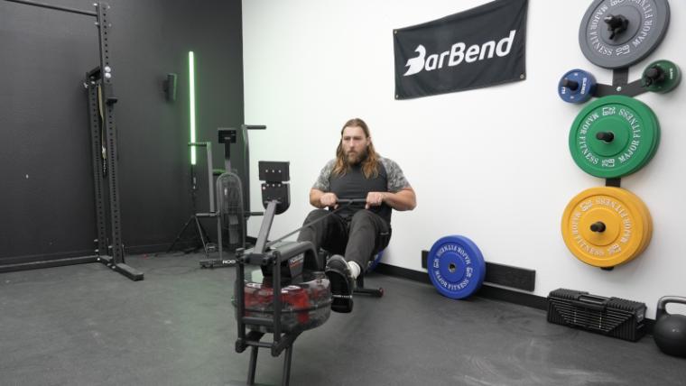 A man rowing on the Yosuda Water Rowing Machine