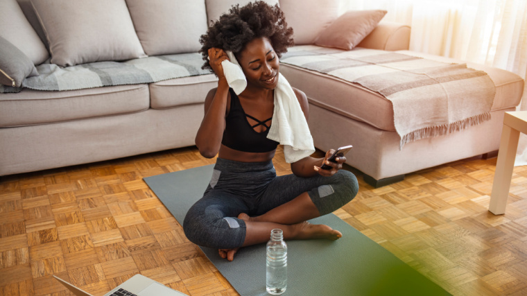 A person checking a mobile app for working out.