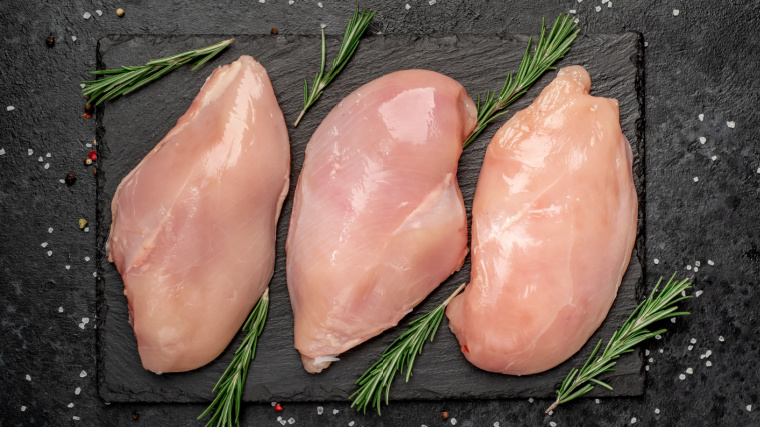 Three pieces of fresh chicken breast.