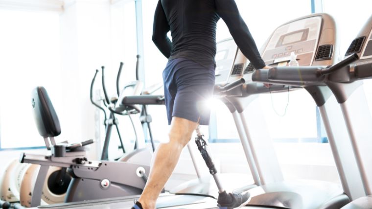 An athlete performs LISS cardio on a treadmill.