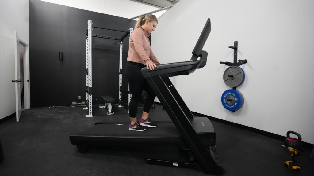 A woman walking on the NordicTrack Commercial 2450 treadmill