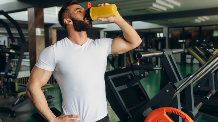 A bodybuilder drinking meal replacement shake.