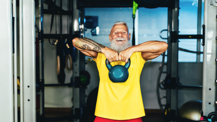 A tattooed senior with a kettlebell.