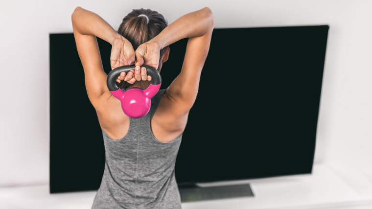 A fit individual doing weight training with a kettlebell.