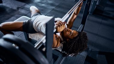 A person doing bench press exercise at the gym