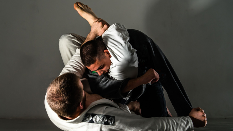 Brazilian Jiu Jitsu fighters training sparring fight triangle submission