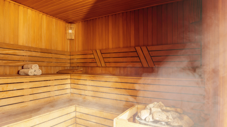 Interior of Finnish sauna, classic wooden sauna with hot steam. 
