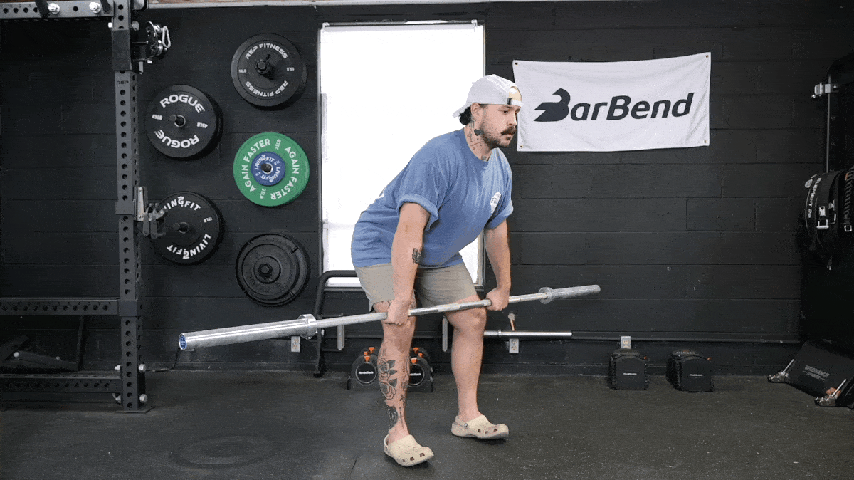 A person doing the hang clean with a barbell.