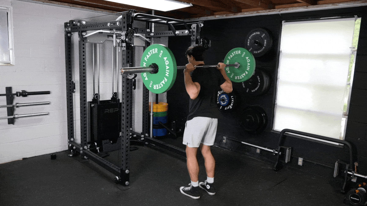 A person doing reverse lunges with a barbell.