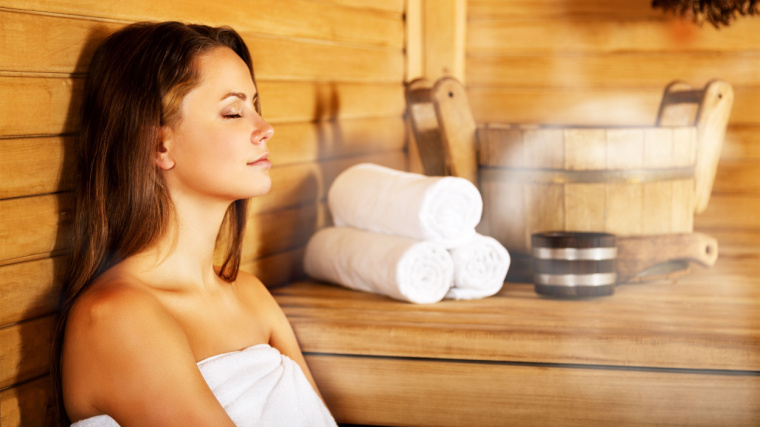 A person relaxing in a sauna. 