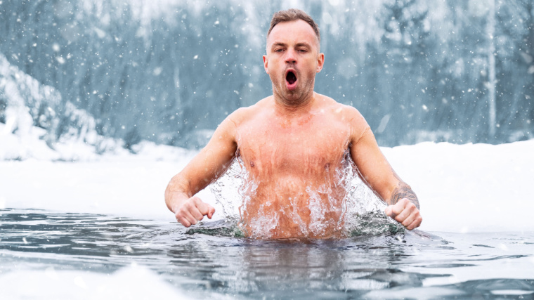 A person slipping into the ice cold lake water.