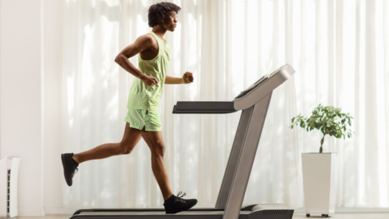 A person running on a treadmill at home.