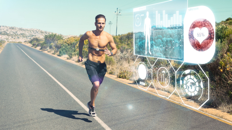 Individual jogging on a deserted road, equipped with a chest strap and smartwatch displaying biometrics.