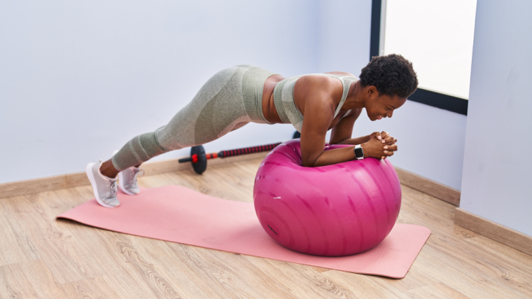 A person doing core workouts with a stability ball. 