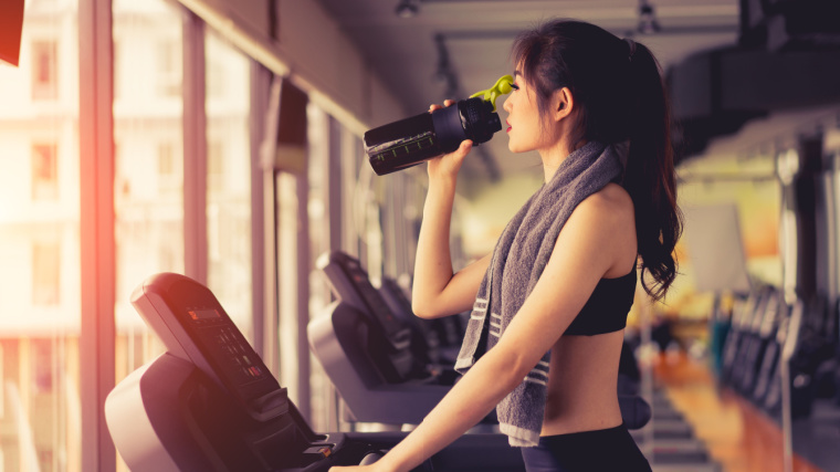 A person drinking a protein shake.