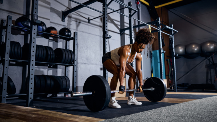 A fit person doing deadlift in the gym.