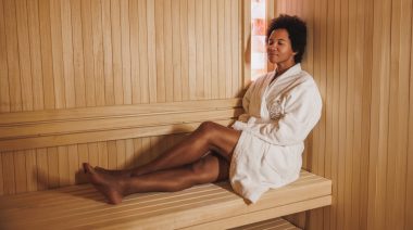 A barefoot person resting in the sauna.