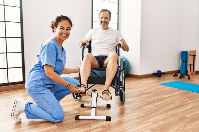 Man in recovery using a mini exercise bike.