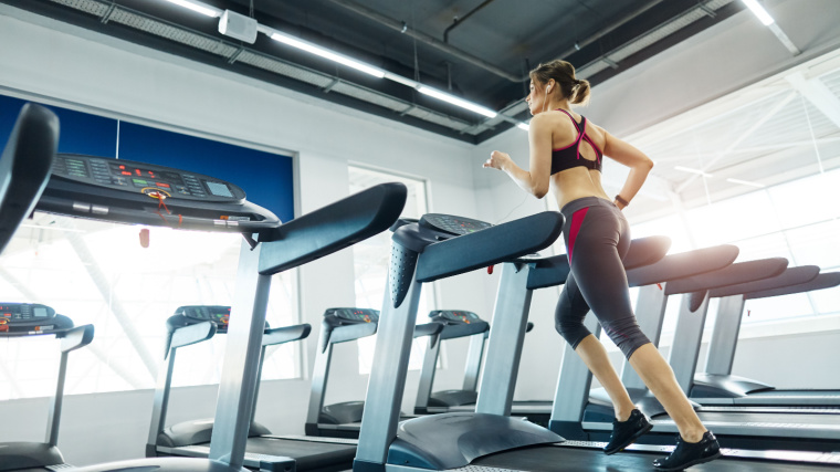 A fit athlete running on a treadmill.