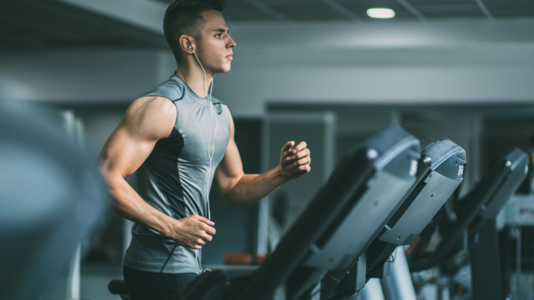 A fit individual running on a treadmill.