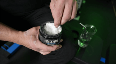 A person scooping Onnit creatine monohydrate.