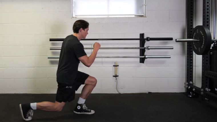 A person performing the walking lunge exercise.