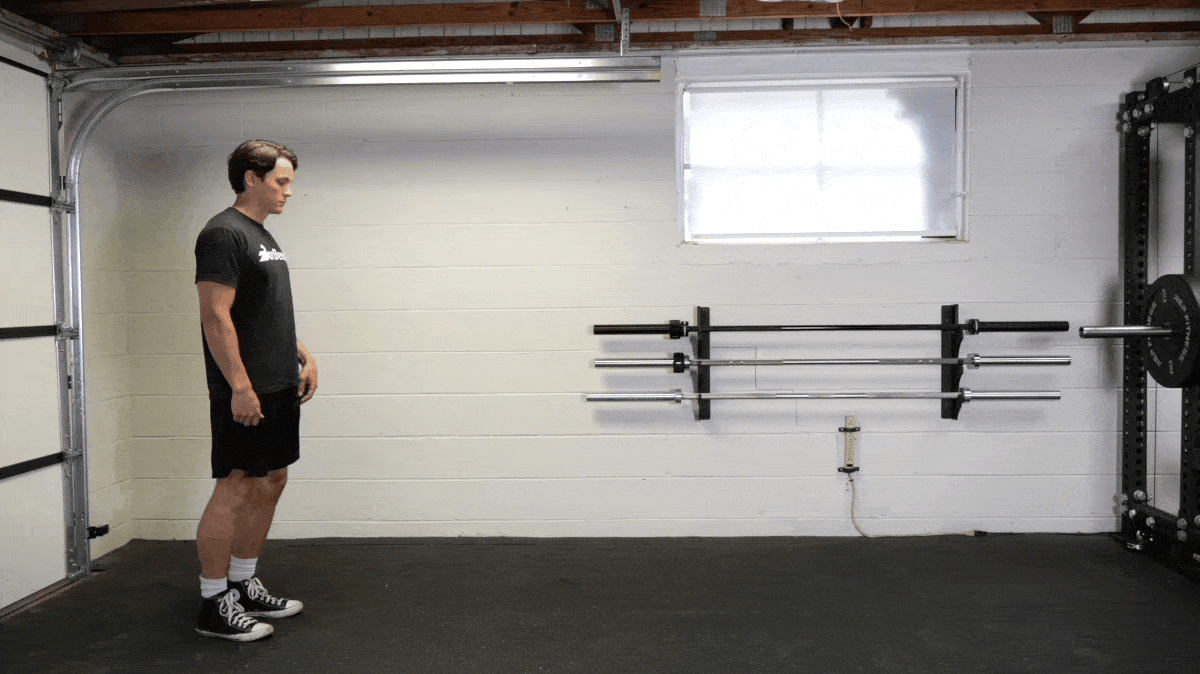 BarBend's Jake Herod doing the walking lunge in the gym.