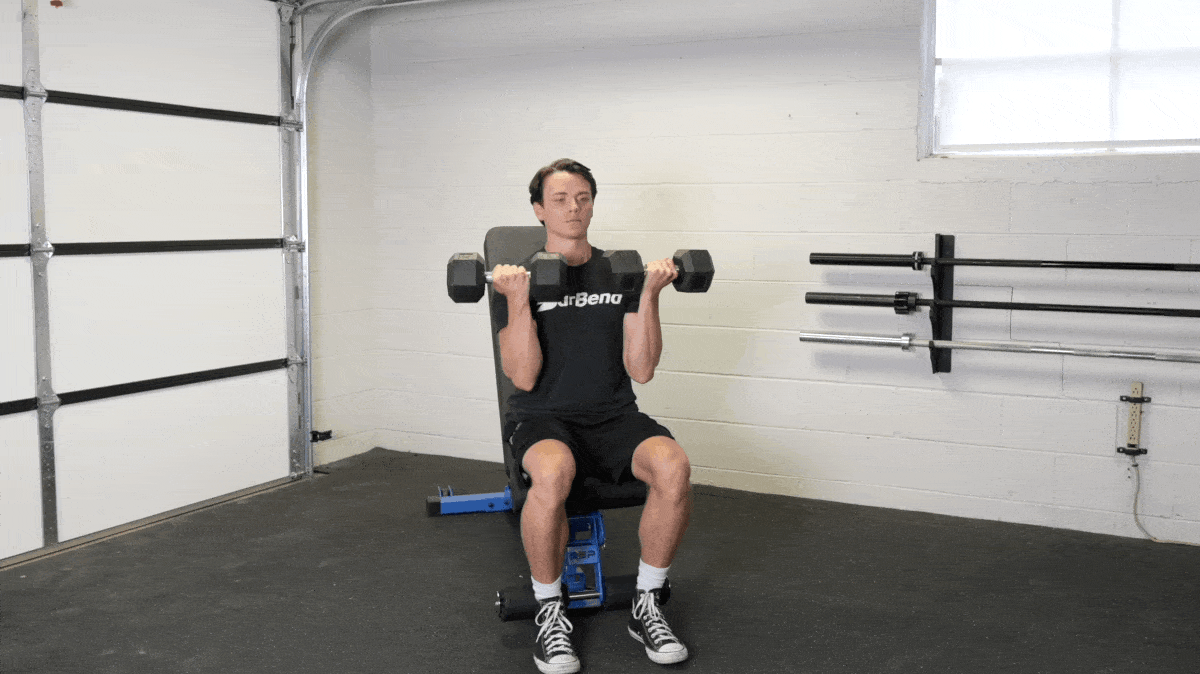A person performing the arnold press exercise.
