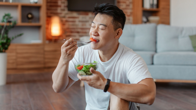 A person eating a salad.