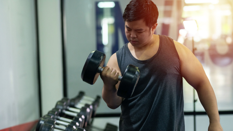 A person lifting a dumbbell.