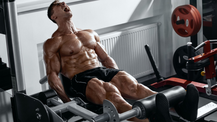 A muscular person performing leg workout in the gym.