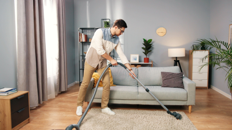 A person vacuuming their house.