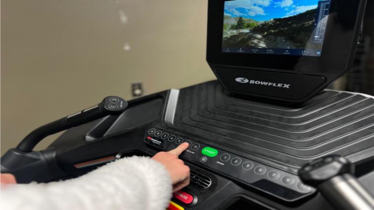 A person is shown adjusting the controls on a BowFlex Treadmill 10.