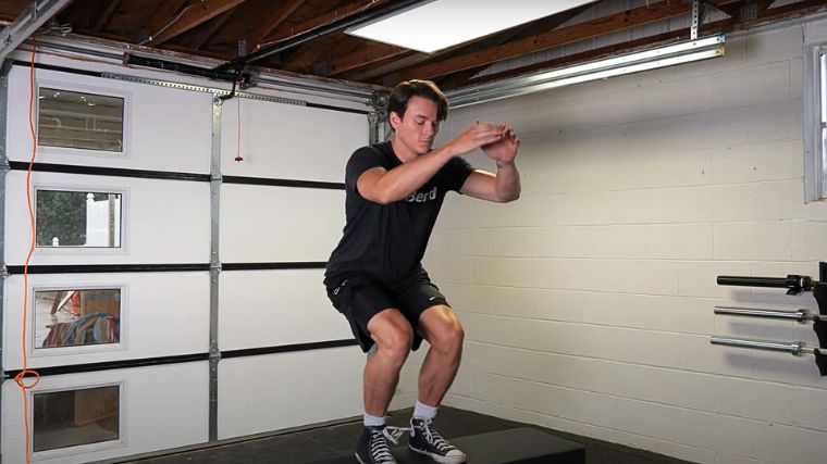 A person performing the box jump exercise.
