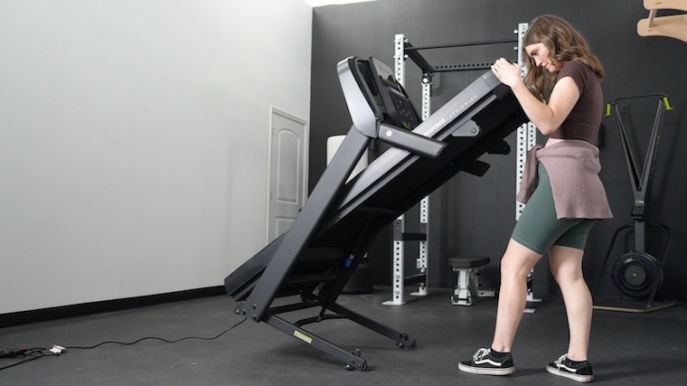 Our tester unfolding the Horizon T101 Treadmill