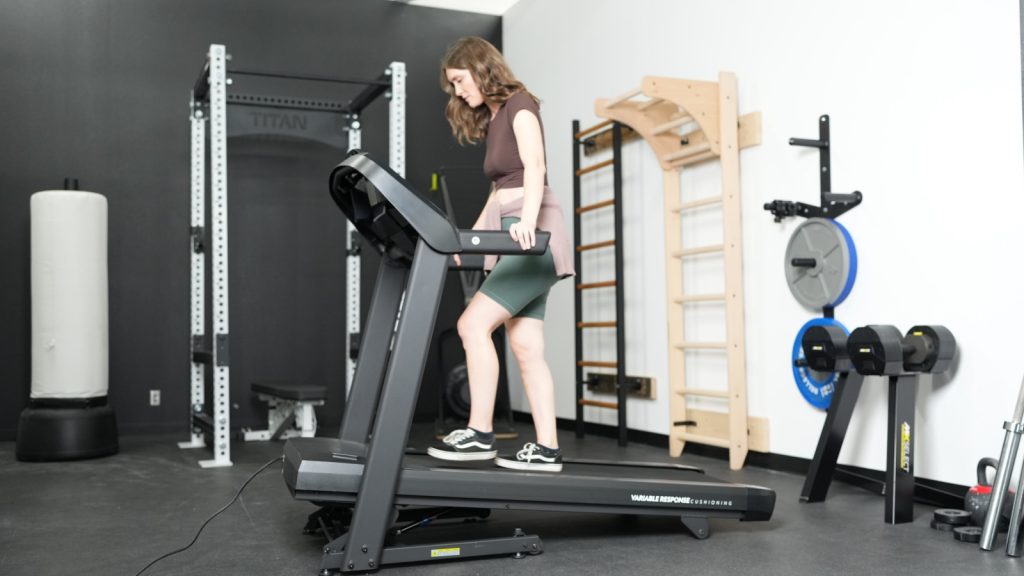 A woman working out on the Horizon T101 treadmill.