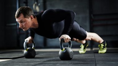 An athlete doing the kettlebell push-up.