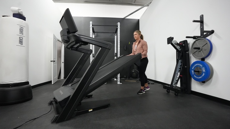 Our tester unfolding the NordicTrack Commercial 1750 treadmill.