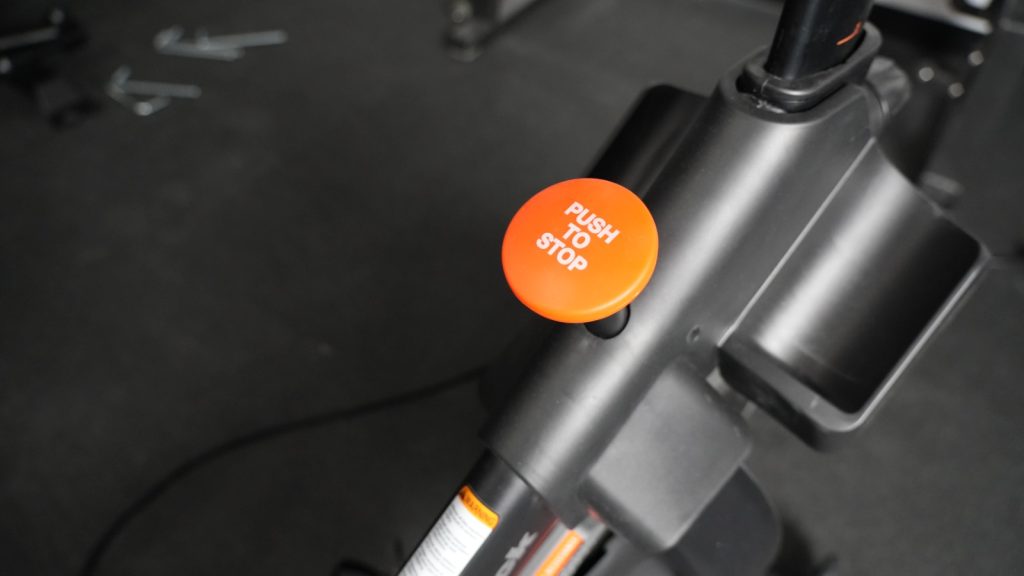 Close up view of the Push-to-Stop knob on a NordicTrack S22i exercise bike.