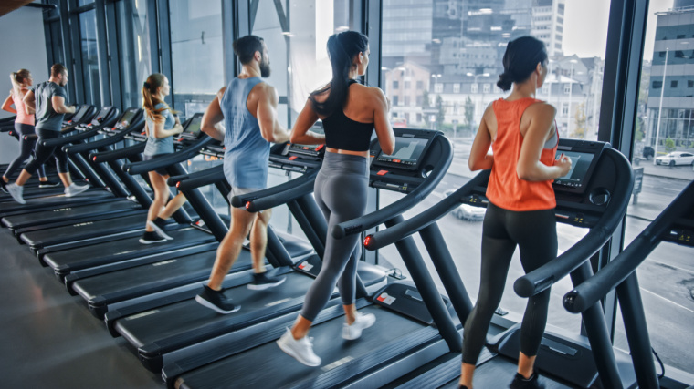 Fit individuals running on treadmills.