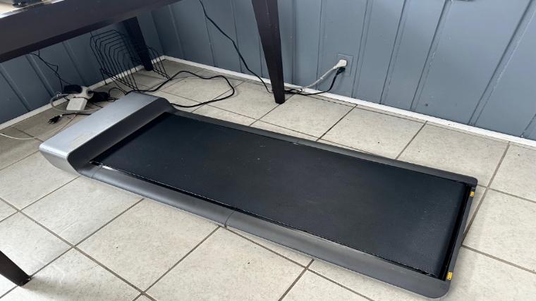The WalkingPad P1 Under Desk Treadmill is shown under a desk