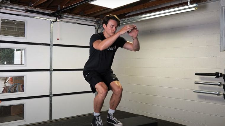 A person performing the box jump exercise.