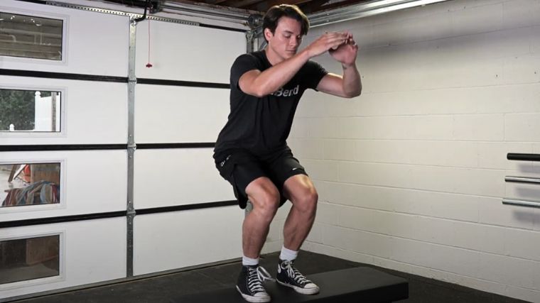 Jake doing the box jump on a weight bench.