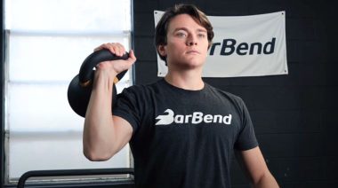 Jake performing the kettlebell circuit workout in the BarBend gym.