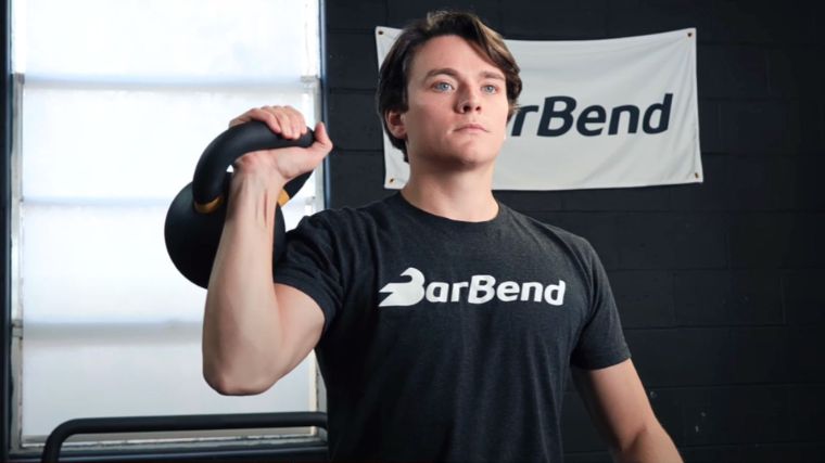 Jake performing the kettlebell circuit workout in the BarBend gym.